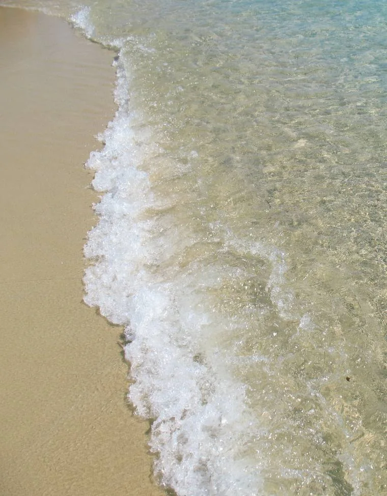 Gentle waves meeting the sand at Plaka Beach